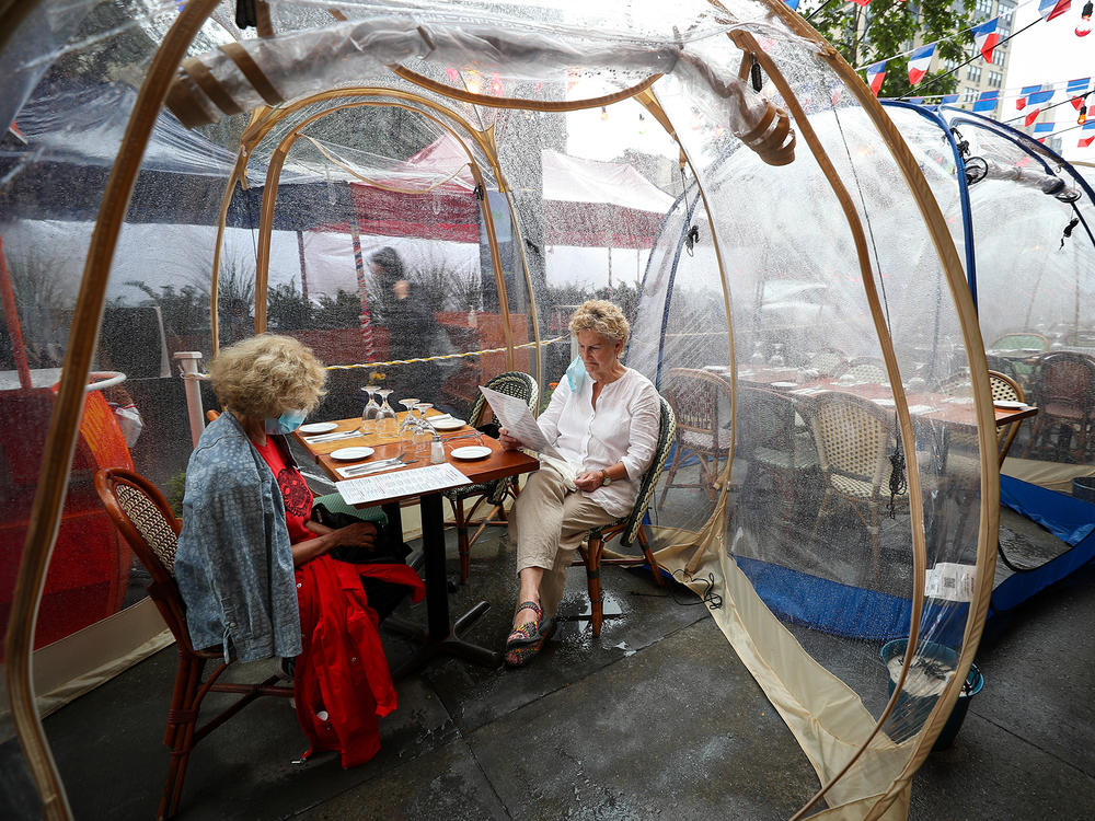 The latest pandemic dining twist is the outdoor bubble, seen here at a New York City restaurant. Sure, it's a way to stay warm as winter looms ... but does it reduce your risk of getting infected by COVID-19?