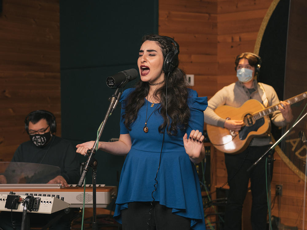 From left, Ron Adea (keyboards), Rawan Tuffaha (vocals) and Jackson D. Begley (guitar) perform during a virtual media appearance on Tue, Oct. 6, 2020 at Metalworks Studios in Mississauga, Ontario, Canada.