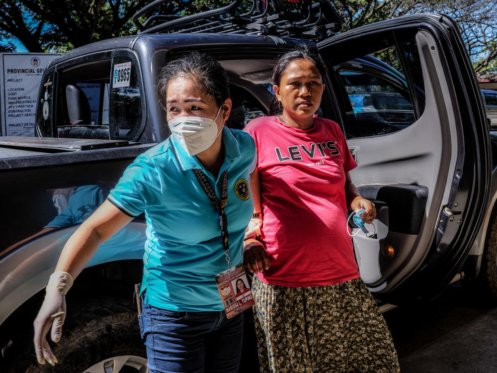 Marissa Tuping, a rural midwife, and Risa Calibuso, right, arrive in Nueva Vizcaya Provincial Hospital on July 21. Calibuso gave birth to her son moments later.