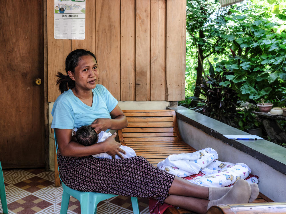 Risa Calibuso breastfeeds her son, Heinrich Claude, in their balcony. He was born on July 27. Calibuso went into labor at home but the local midwife would not participate in a home delivery. Because there were no other options to get Calibuso to the Nueva Vizcaya Provincial Hospital for delivery, the reporter gave her a ride.