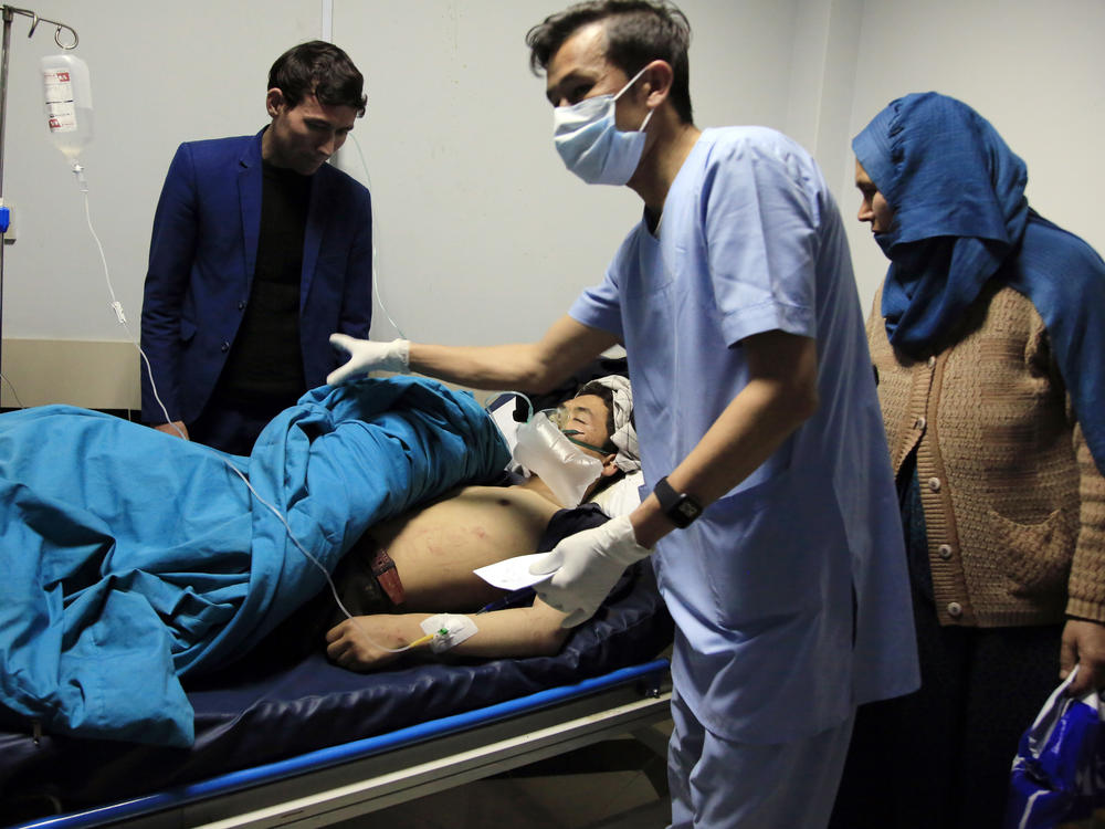 Patients are treated at a hospital after a suicide attack in Kabul, Afghanistan, on Saturday. Dozens were injured.