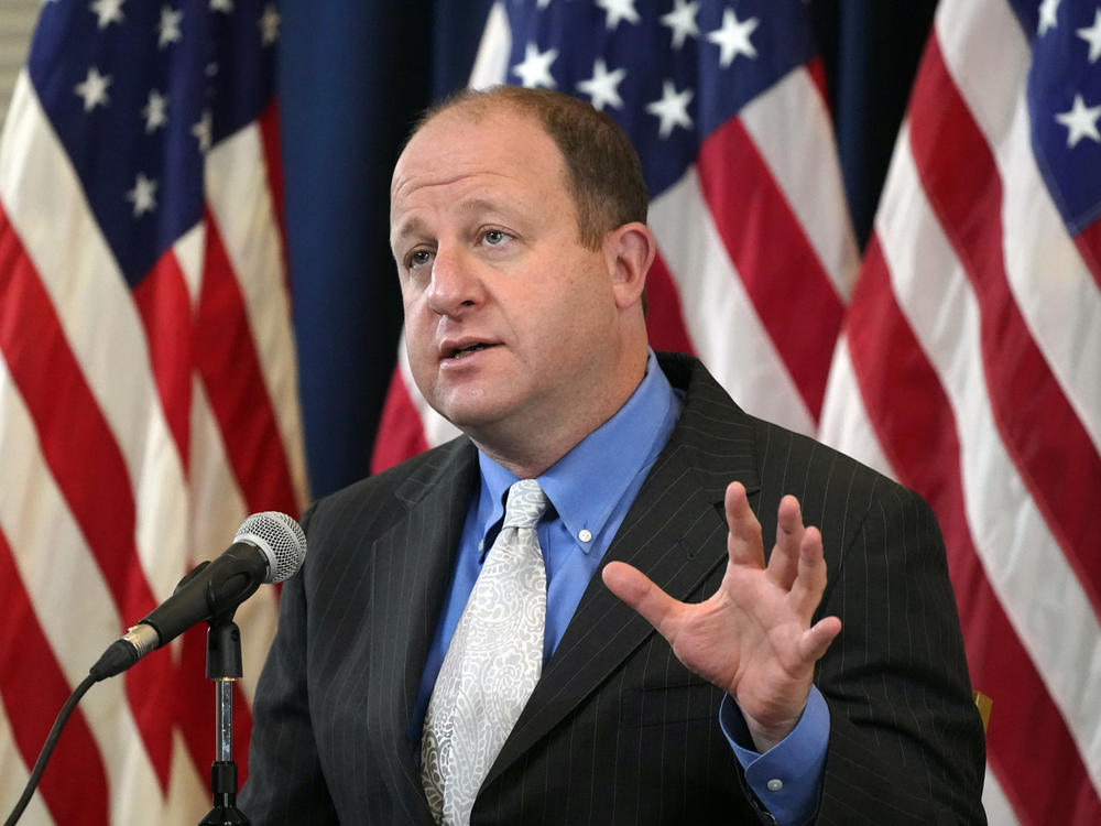 Colorado Gov. Jared Polis speaks during a news conference on Oct. 20 about the steady increase in new coronavirus cases in the state.