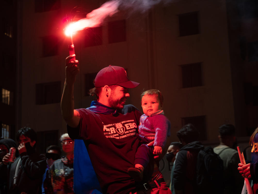 A family celebrates the approval of a new constitution in Santiago, Chile. After decades, the constitution from the country's years of dictatorship will finally be thrown out.