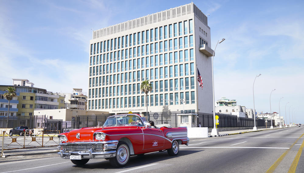 A car drives past the U.S. Embassy in Havana in 2019. More than 40 Americans working at the embassy suffered from unexplained ailments that included headaches, balance problems and memory loss.