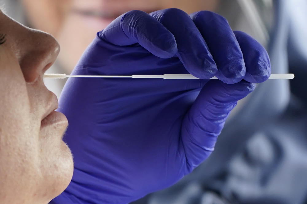 A Salt Lake County Health Department public health nurse performs a coronavirus test outside the Salt Lake County Health Department. On Friday, Oct. 23, 2020, Utah hit an all-time high of nearly 2,000 confirmed cases in one day.