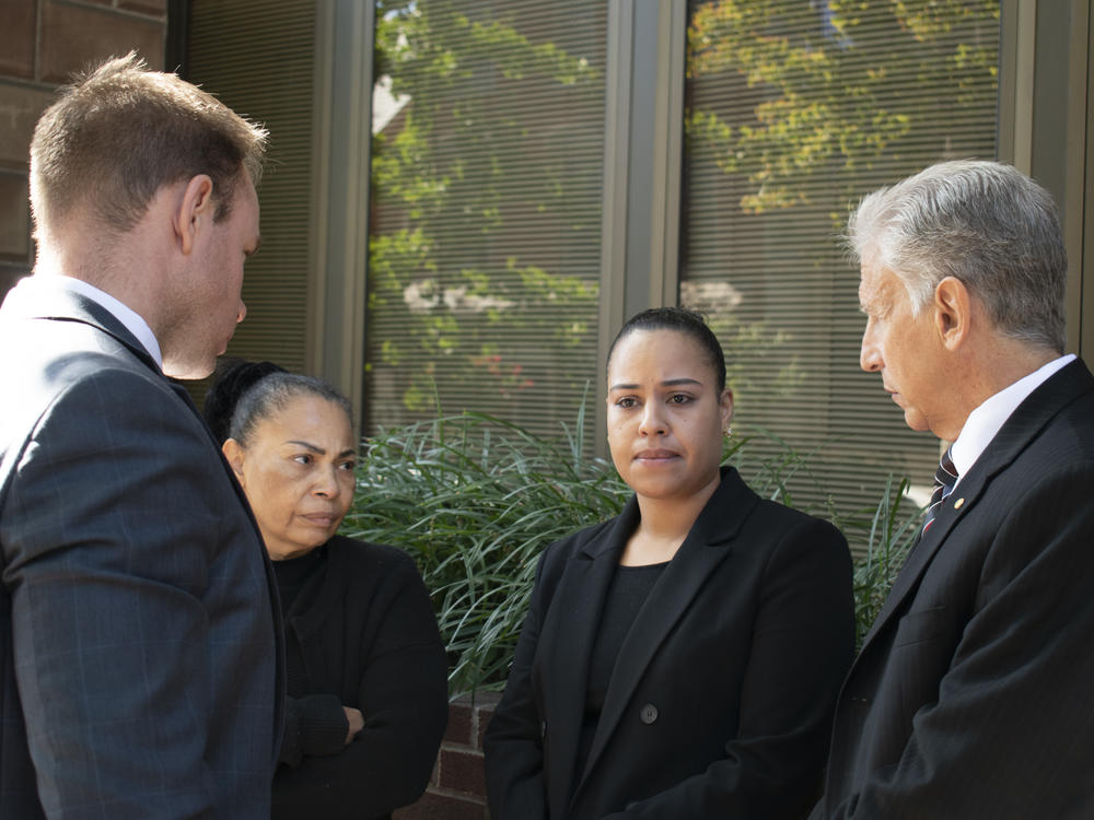 Rulennis Munoz (center right) outside Lancaster Courthouse Oct. 14, after learning that the police officer who fatally shot her brother had been cleared of criminal wrongdoing by the Lancaster County District Attorney. Her mother, Miguelina Peña, and her attorney Michael Perna (far right) stood by.