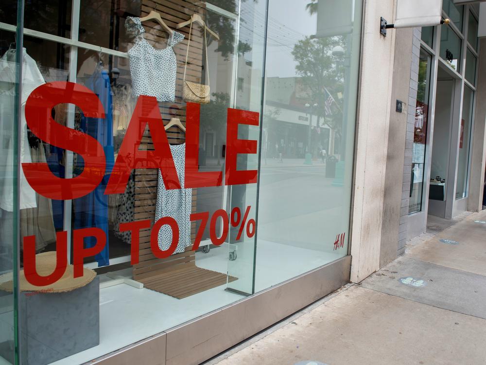 A store advertises discounts in Santa Monica, Calif., on July 28 amid the coronavirus pandemic. Economic growth data on Thursday are expected to show a record-setting figure for the third quarter, but that covers the more worrisome picture underneath the surface.