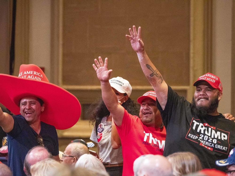 Supporters of President Trump wave during a Latinos for Trump roundtable last month at the Arizona Grand Resort in Phoenix.