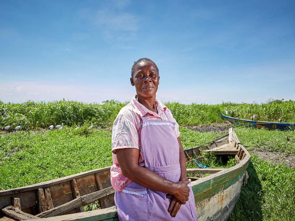 Alice Amonde sits on a boat on the village of Nduru Beach, Kenya. She is part of the group of women who have fought against the practice of transactional sex that was part of the fishing business. This photograph was taken in November 2019. This spring, flooding from Lake Victoria devastated the village.