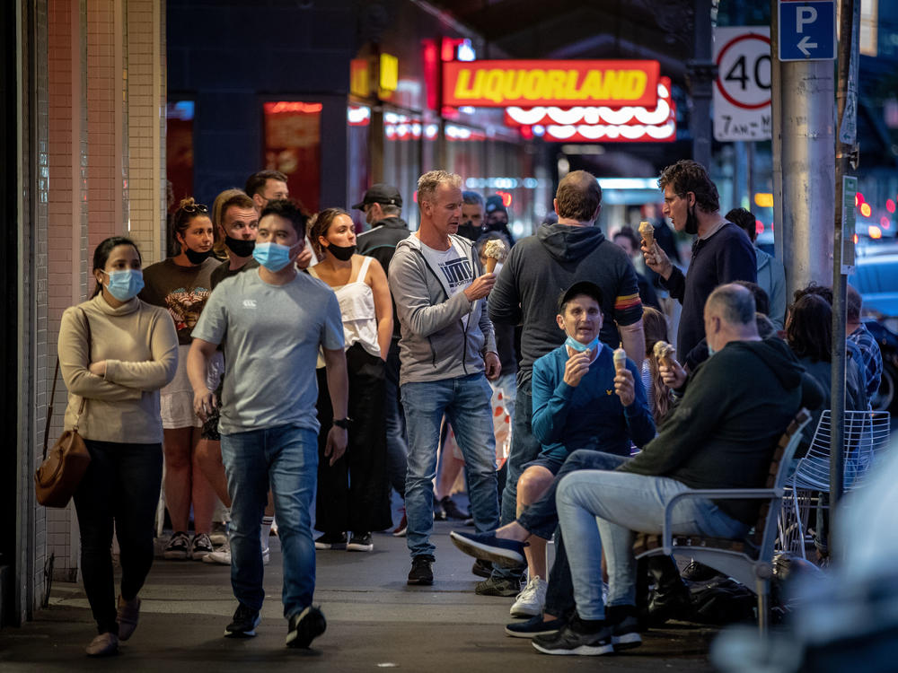 People enjoy eating outdoors on Wednesday in Melbourne, Australia. Lockdown restrictions in the city were lifted after 111 days, allowing people to leave their home for any reason.