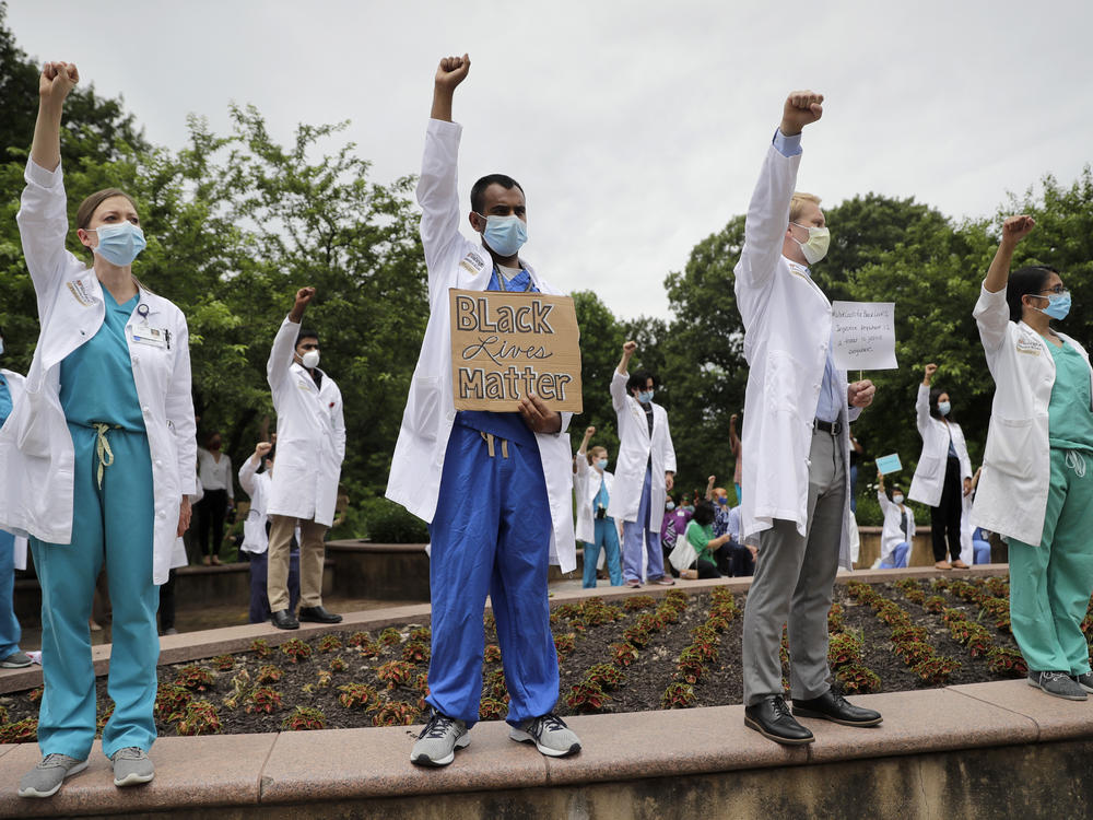 Health care professionals gather outside Barnes-Jewish Hospital in St. Louis in June to demonstrate in support of the Black Lives Matter movement.