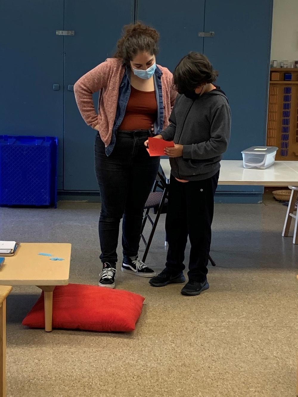 Xavier, a fifth grader, shows his teacher Raisa Luna GuzmÃ¡n the comic book he made for his virtual language arts class.