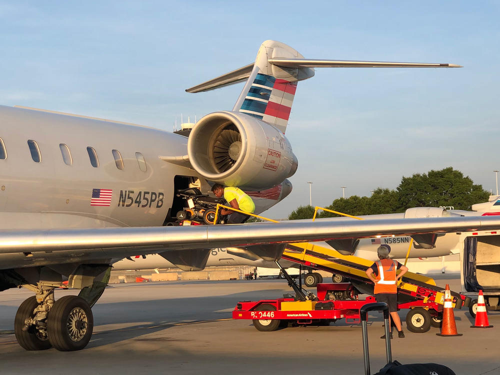 Morris' wheelchair is loaded onto an airplane.