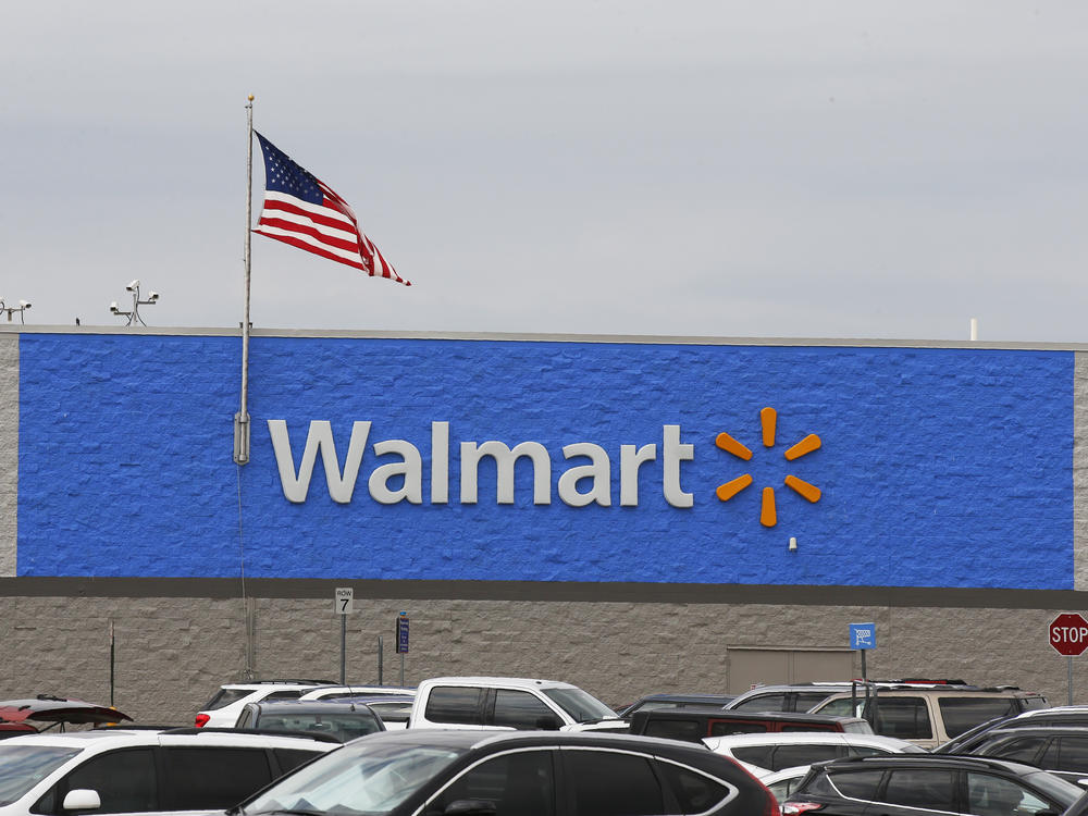 A U.S. flag waves over a Walmart parking lot in August in Oklahoma City. The company sells firearms in about half of its 4,700 stores in the United States.