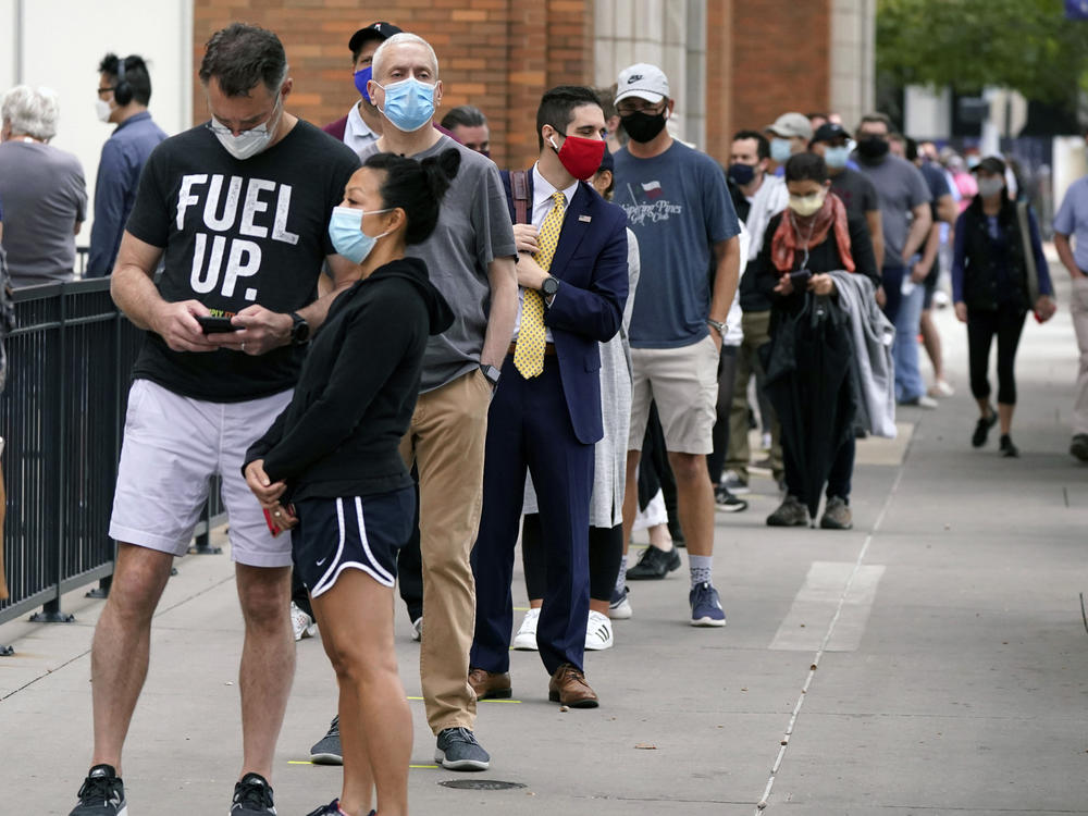 Voters line up at the American Airlines Center during early voting in mid-October in Dallas.