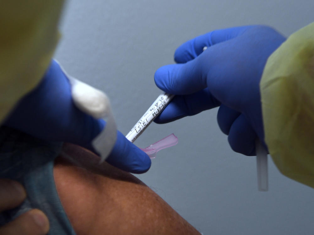 Tony Potts, a 69-year-old retiree living in Ormond Beach, Fla., receives his first injection earlier this year as a participant in a Phase 3 clinical trial of Moderna's COVID-19 candidate vaccine.