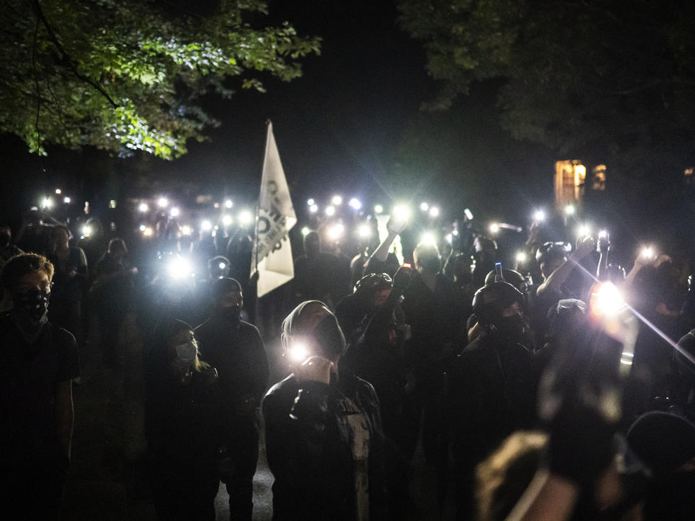 Protesters chant while marching to the Penumbra Kelly Building during a protest against racial injustice and police brutality on Oct. 2 in Portland, Ore. Portland's regular protests continued this week, staying mostly peaceful and without confrontations between police and demonstrators.
