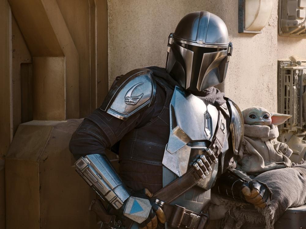 The Mandalorian (Pedro Pascal) and The Child in Season 2 of <em>The Mandalorian on </em>Disney+.