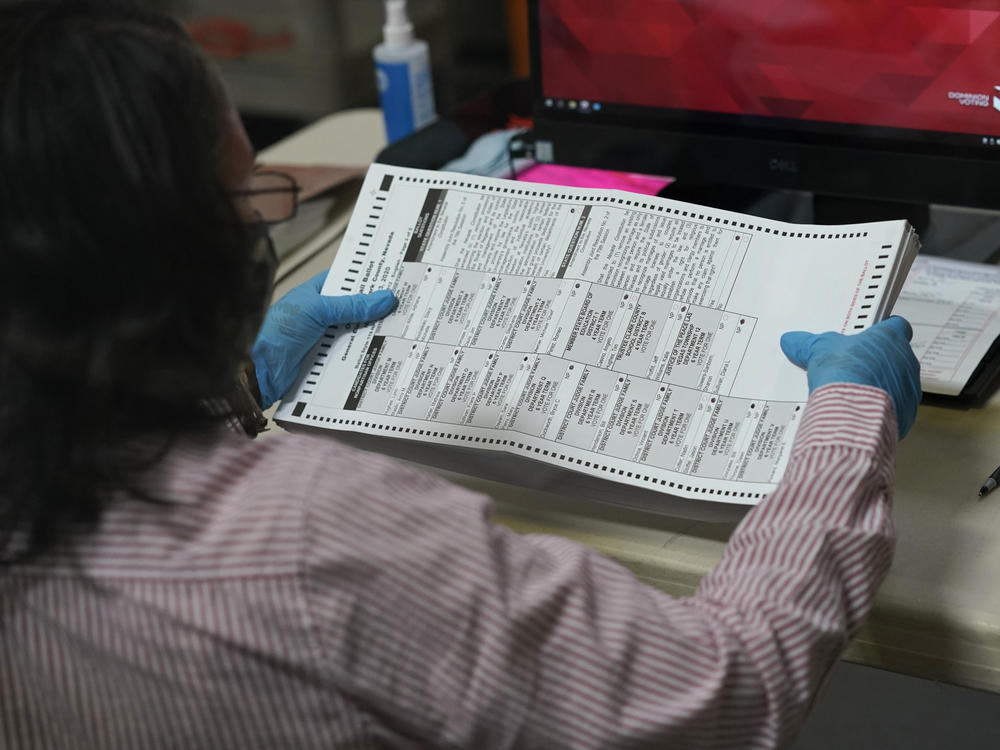 A county worker loads mail-in ballots into a scanner that records the votes at the Clark County Election Department last Thursday in Las Vegas.