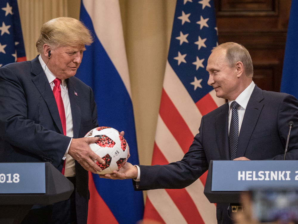 Russian President Vladimir Putin hands President Trump a World Cup soccer ball during a joint news conference after their July 2018 summit in Helsinki.