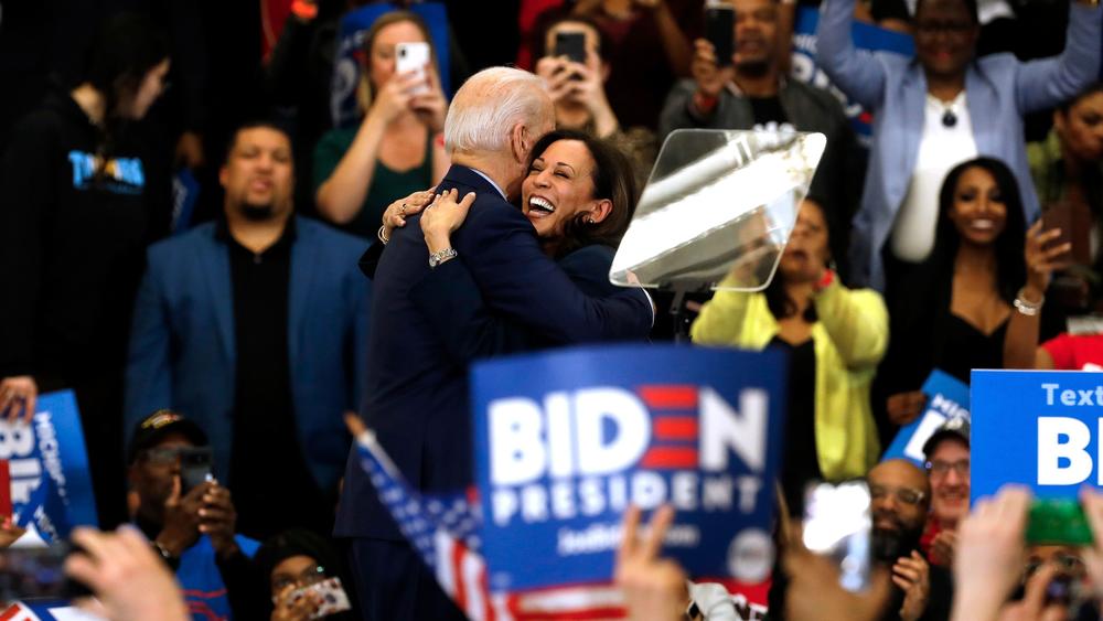 Biden hugs his former primary rival and future running mate, California Sen. Kamala Harris, after she endorsed him at a campaign rally in Detroit on March 9.