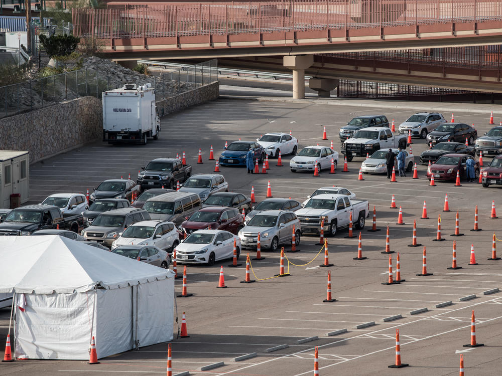 Cars wait in line at a coronavirus testing site at the University of Texas at El Paso Saturday. As El Paso reports record numbers of active coronavirus cases, the Texas attorney general sued to block local shutdown orders.