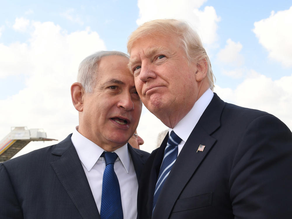 Israeli Prime Minister Benjamin Netanyahu speaks with Trump before the president's departure from Ben-Gurion International Airport in Tel Aviv in May 2017. The visit was part of Trump's first Middle East trip after taking office.