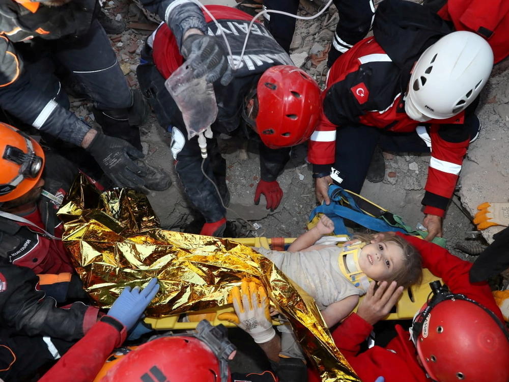 Rescue workers carry Ayda Gezgin away from where she was trapped by rubble after a building collapsed during last week's earthquake in the Aegean port city of Izmir, Turkey.