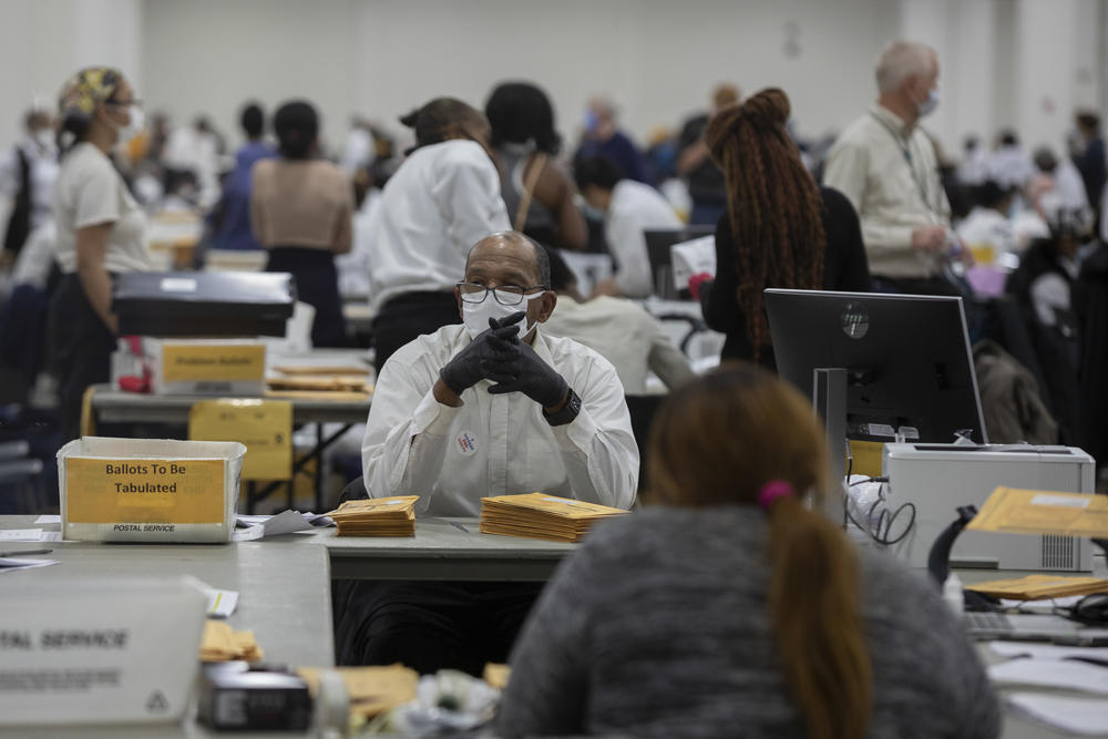 A worker with the Detroit Department of Elections waits for the next absentee ballot to be sorted through at the Central Counting Board in the TCF Center on Nov. 4.