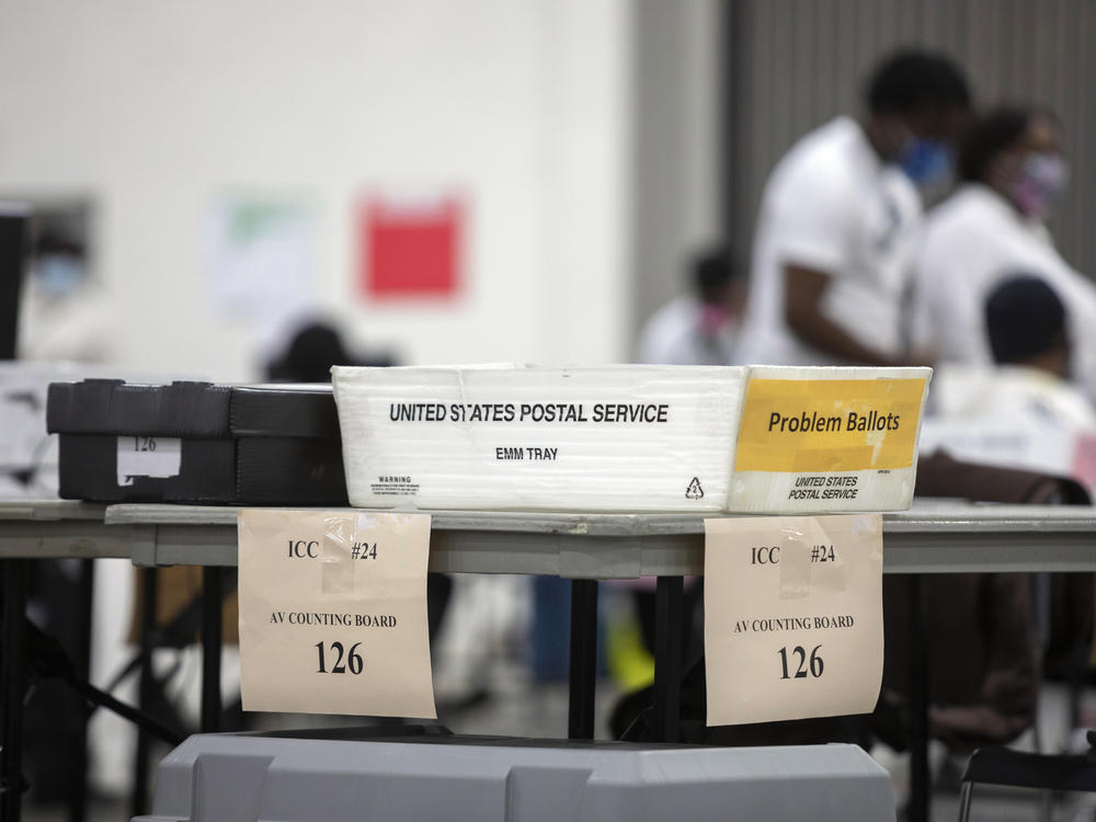 A problem ballot box is placed on the end of a table where workers with the Detroit Department of Elections sorts through absentee ballots.