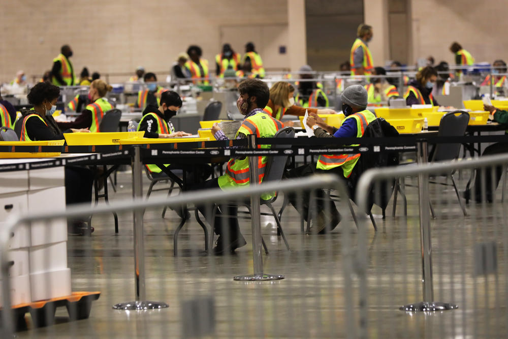 Election workers count ballots on November 3 in Philadelphia. While the election was logistically complicated and there were efforts by foreign and domestic actors to disrupt the election, it appears a record number of Americans cast ballots.