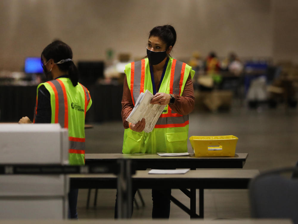 Election workers in Philadelphia count ballots on Tuesday. Pennsylvania is among several swing states that have yet to be called.