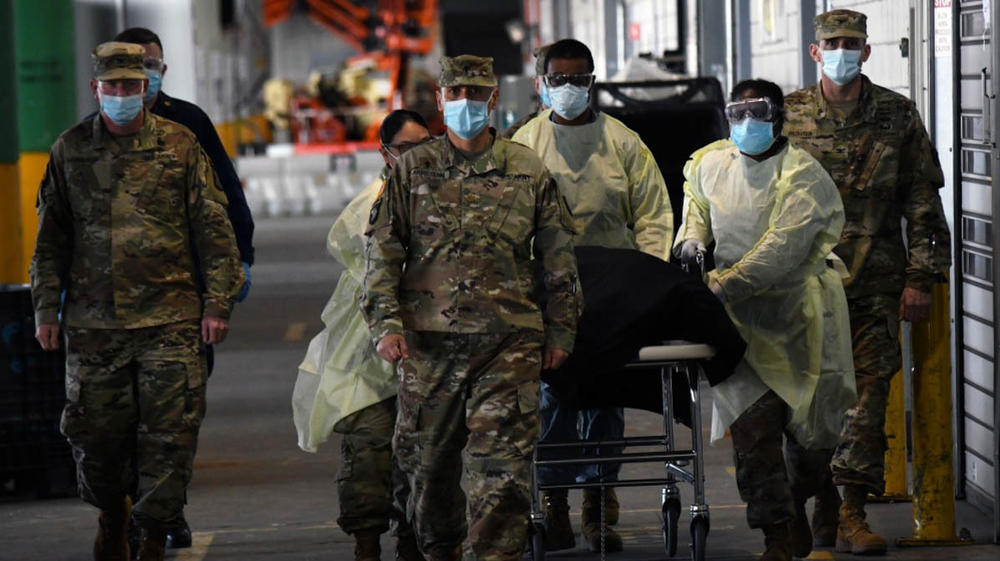 Army (Chaplain) Maj. Ivan Arreguin and other soldiers escort the remains of a veteran who died from COVID-19 while being treated at the Javits New York Medical Station, in New York City, in April.