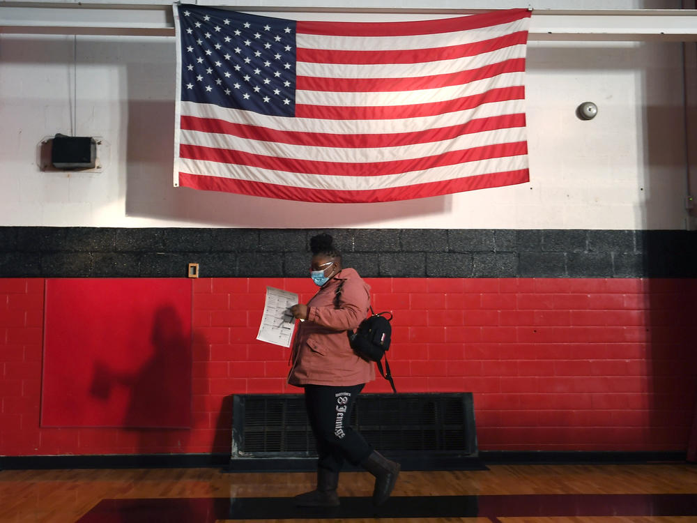 A voter casts a ballot on Tuesday at Jennings Senior High School in Jennings, Mo., a St. Louis suburb. Voters passed an amendment to Missouri's constitution that opens the door to redrawing state legislative districts that don't take into account children, noncitizens and other residents who are not eligible to vote.