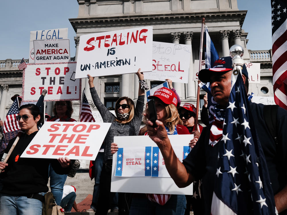 People call for stopping Pennsylvania's vote count Thursday at the state Capitol in Harrisburg. False claims of voter fraud and calls to protest have spread on social media, leading Facebook to take down one large group.