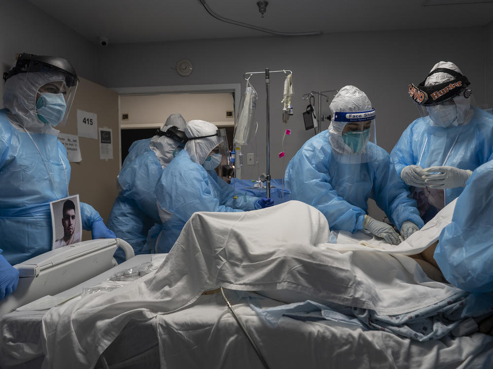 Medical staff members treat a patient with COVID-19 last week in the intensive care unit of United Memorial Medical Center in Houston. Once a COVID-19 vaccine is available, experts say immunizing health workers first is the best way to curb deaths and stop transmission.