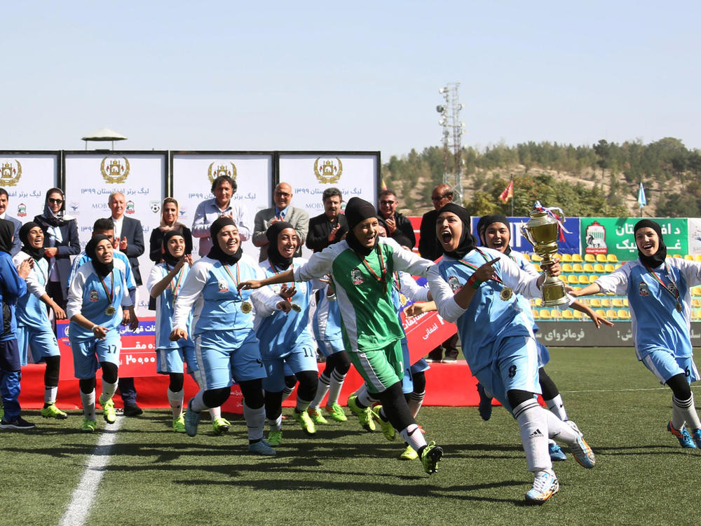 Players from the Herat Storm celebrate after winning the championship of the Afghan women's soccer league on October 16 in Kabul.
