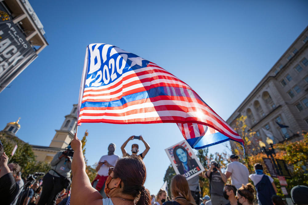 People celebrate Joe Biden becoming the 46th president of the United States on Black Lives Matter Plaza at 16th and H Streets.