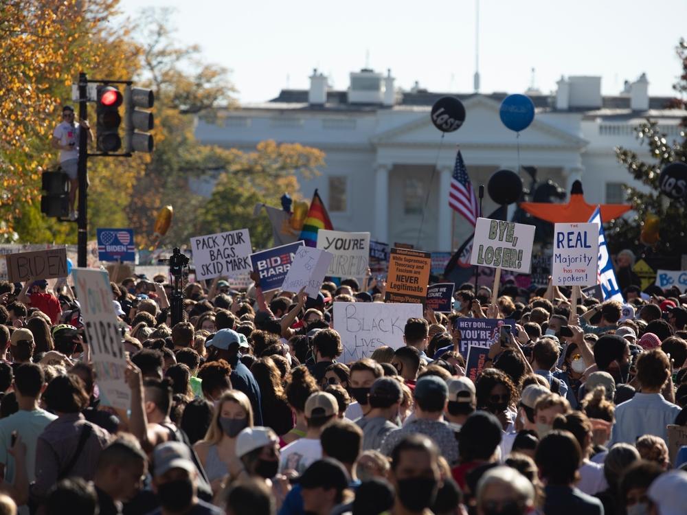 People celebrate Saturday at Black Lives Matter Plaza across from the White House in Washington, D.C., after Joe Biden was declared the winner of the 2020 presidential election.