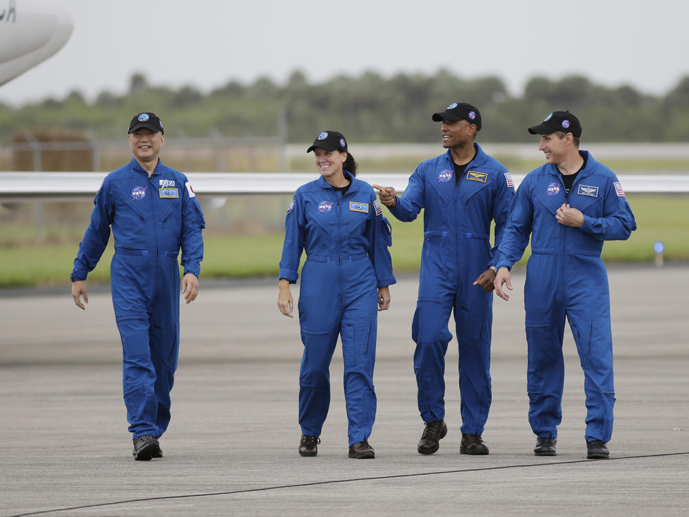 From left, astronaut Soichi Noguchi of Japan and NASA astronauts Shannon Walker, Victor Glover and Michael Hopkins walk after arriving at Kennedy Space Center in Cape Canaveral, Fla. The four astronauts will fly on the SpaceX Crew-1 mission to the International Space Station scheduled for launch on Saturday.