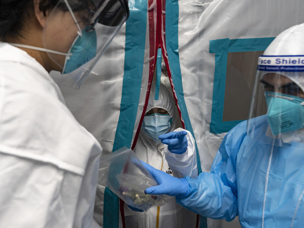 Medical staff members wear protective gear while working at the COVID-19 Intensive Care Unit at United Memorial Medical Center in Houston on Sunday.