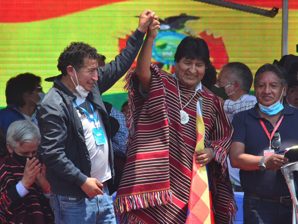 Former Bolivian President Evo Morales (middle) greets supporters during a welcoming ceremony after he crossed the border from Argentina after one year in exile on Monday, in Villazón, Bolivia.