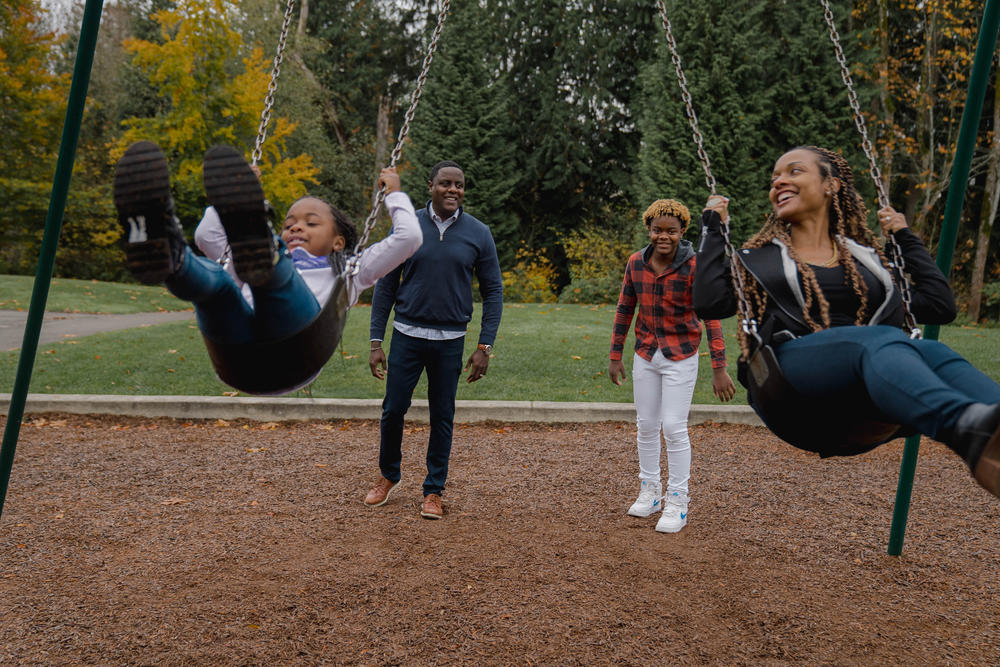Will Station, a vice president at Boeing (second from left) plays with his children, Taylor (left) and Jaden, and his wife April, near their home in Newcastle, Wash. During the pandemic, Station has not traveled for work, so he's spent a lot more time at home with his family.