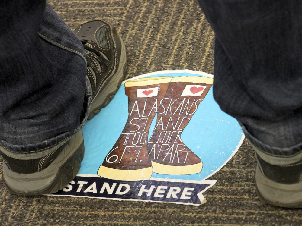 Social distancing floor stickers are seen at a mall last month during early voting in Anchorage, Alaska.