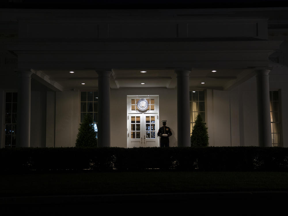 A Marine stands outside the entrance to the West Wing of the White House on Tuesday, signifying that President Trump is in the Oval Office.