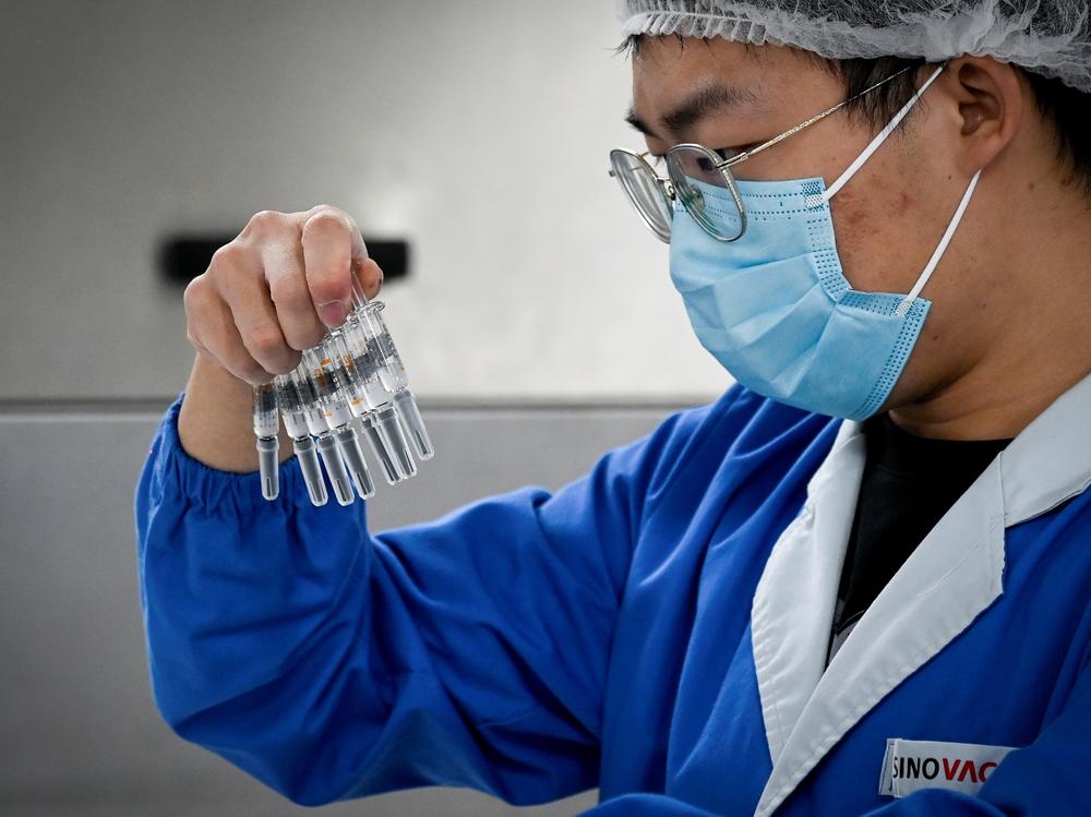 A staff member checks vaccines at a Beijing factory built by Sinovac to produce a COVID-19 coronavirus vaccine. Sinovac is one of 11 Chinese companies approved to carry out clinical trials of potential vaccines.