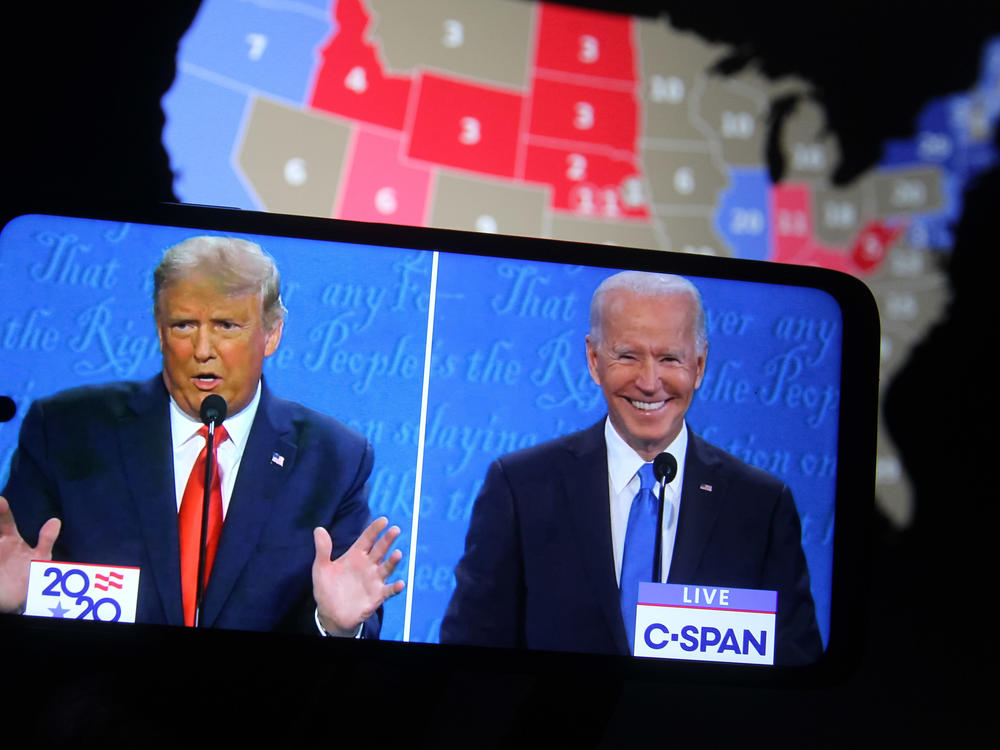 Some major final steps for the 2020 census are set to take place during the transition from President Trump to President-elect Joe Biden, who both appear above on a smartphone displaying the final presidential debate in October.