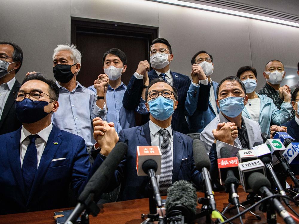Pro-democracy lawmakers at the start of a news conference in a Legislative Council office in Hong Kong on Wednesday. The legislators are resigning en masse over a new law from Beijing that led to the ouster of four of their fellow lawmakers.