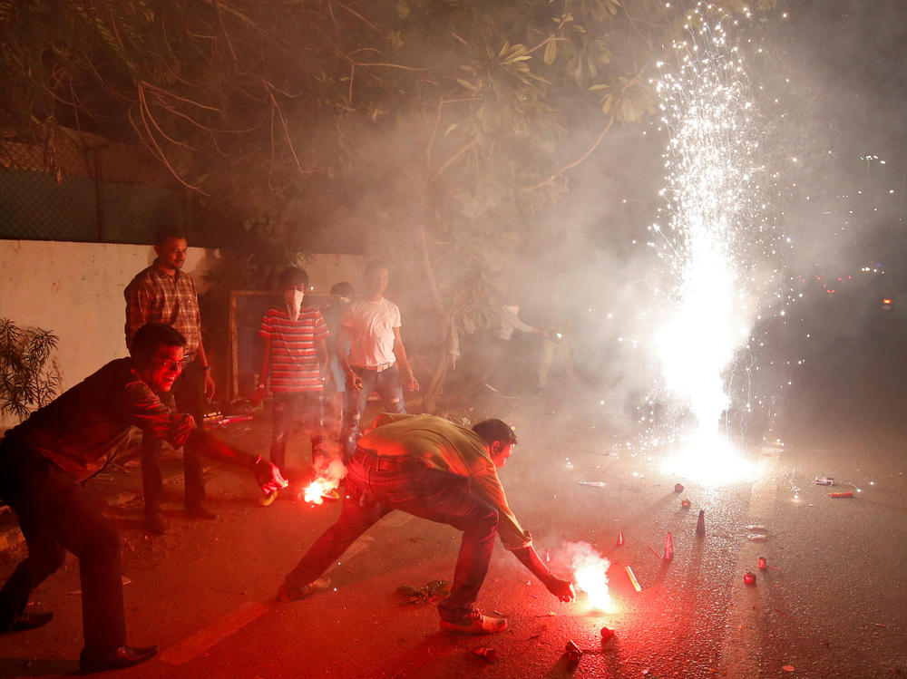 The fireworks of Diwali, the Hindu festival of lights, add smoke to the already polluted skies — and raise concerns about the impact of all that pollution on coronavirus cases. Here, a celebration takes place last year in Ahmedabad, India.