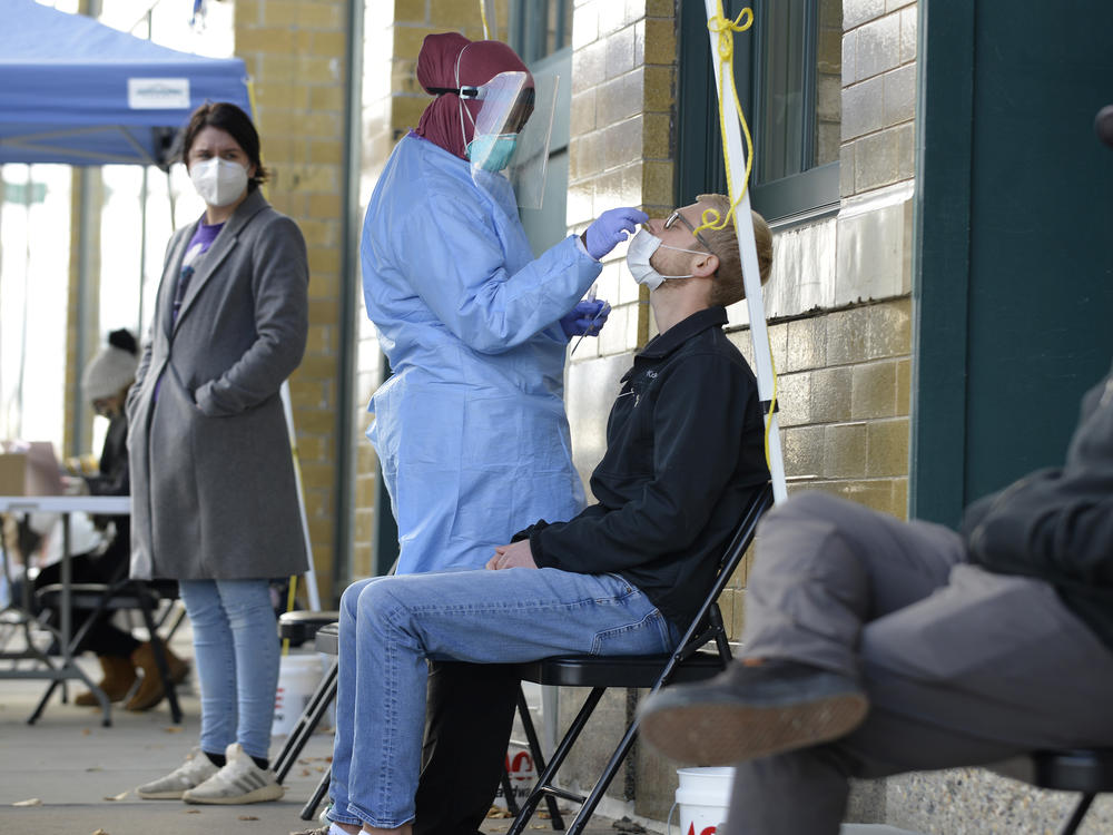 A medical staff member performs a COVID-19 test outside the Family Healthcare building in downtown Fargo, North Dakota, on Oct. 15. North Dakota is experiencing an influx in COVID-19 cases and on Nov. 6, the state reported a record high of 1,765 daily new cases.